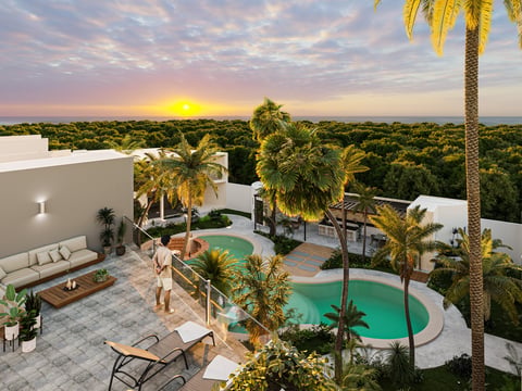 Aerial view of modern white luxury villa with turquoise pool, palm trees, and expansive green landscape at sunset