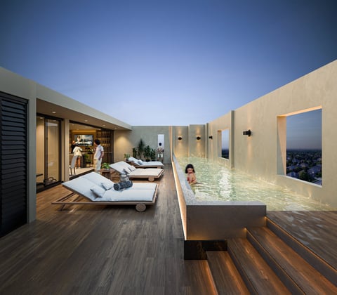 Modern rooftop terrace with loungers, hot tub, and city views at sunset
