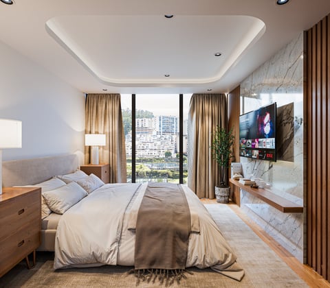 Modern bedroom with bed, wood nightstands, large windows overlooking city skyline, curtains, mounted TV, and ensuite bathroom view