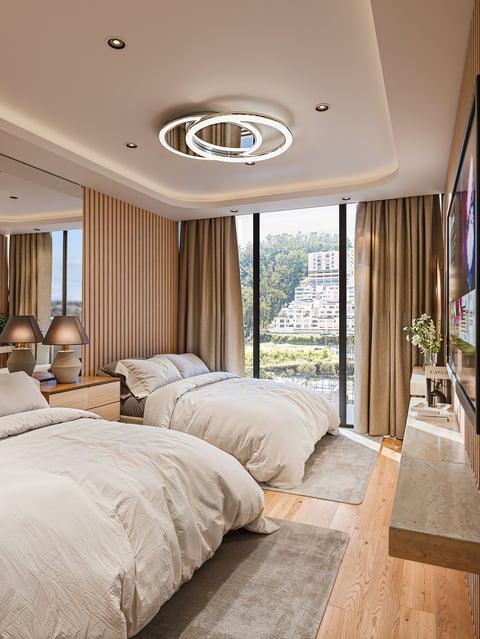 Modern bedroom with two twin beds, large windows with city views, beige curtains, wooden flooring, recessed ceiling lights, and contemporary decor