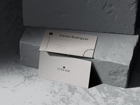 Business cards for Carlos Rodriguez displayed on concrete blocks in minimalist black and white styling