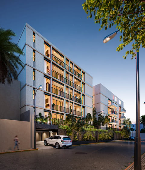 Modern multi-story residential apartment building with balconies, white and warm-toned facade, palm trees, and parked car in driveway at dusk