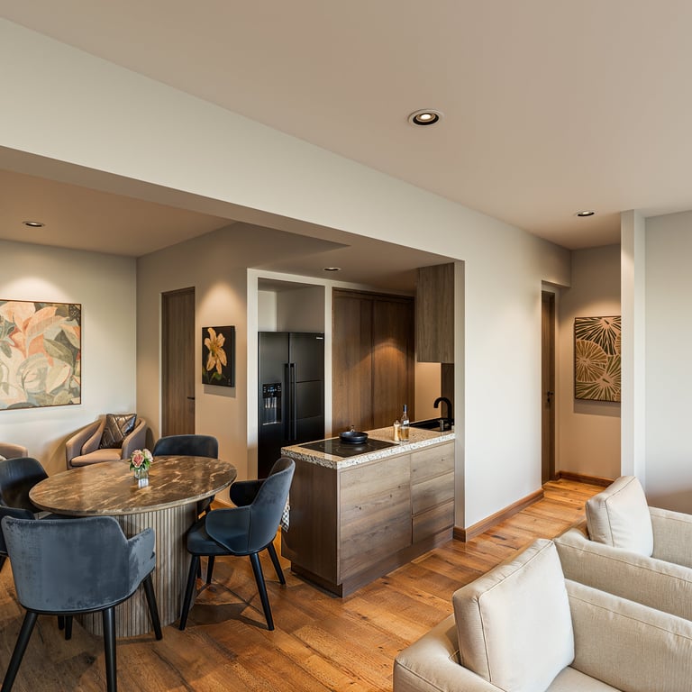 Modern open-concept apartment interior with wood flooring, dining area with blue chairs, kitchen with black range hood, and living room seating